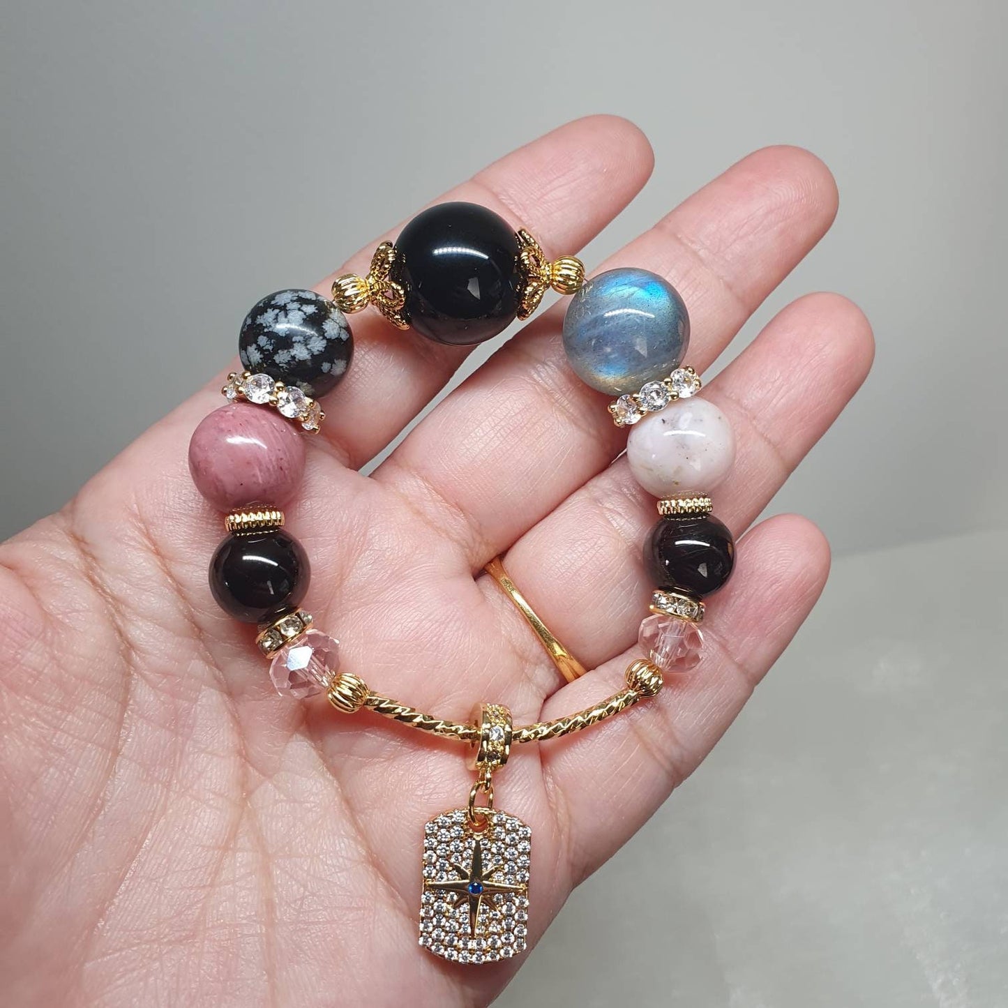 Handcrafted bracelet with Rainbow Obsidian, Snowflake Obsidian, Rhodonite, Grey Moonstone and Red Garnet